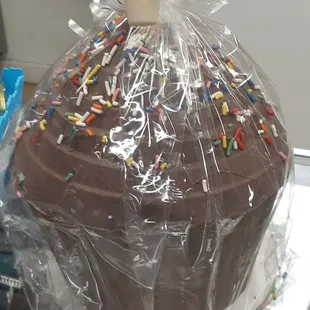 Chocolate cupcake filled with truffles.  Hammer attached to break it open.