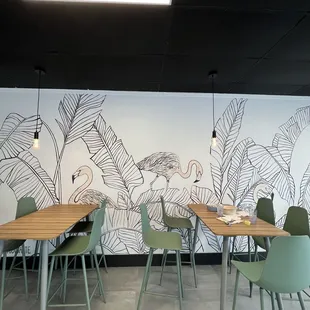 a dining area with tables and chairs