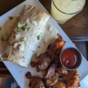 Banger Sausage, Cheese Blend, Roasted Red Peppers, and Breakfast Potatoes Rolled into a Tortilla and Smothered in Our House Sausage Gravy