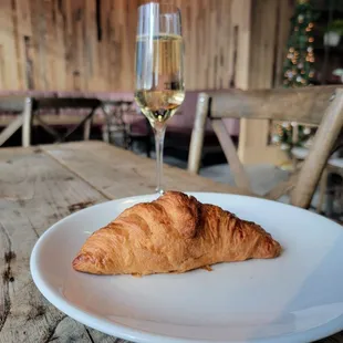 a croissant and a glass of wine
