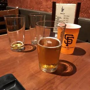 three glasses of beer on a table