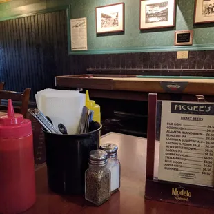 a table with condiments and a menu