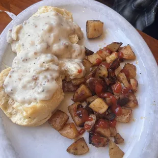Side of biscuits and gravy and potatoes.