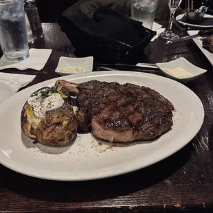 Bone in rib-eye with loaded baked potato
