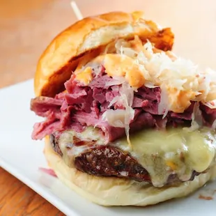 a beef sandwich with sauerkraut and cheese