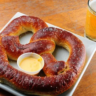 a pretzel and a glass of beer