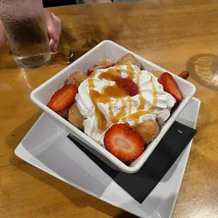 Fried Doughnuts with Whipped Cream and Strawberry Garnish