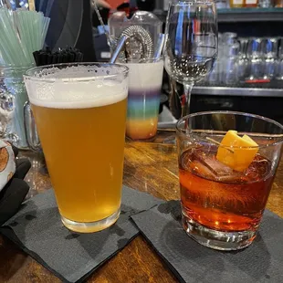 two glasses of alcohol on a bar