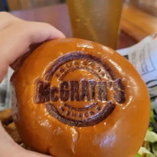 a hand holding a burger