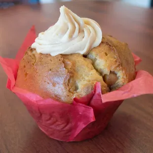 a muffin with whipped cream on top