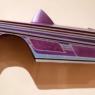 Another exhibit in the low rider section. A part of a sparkling purple car.
