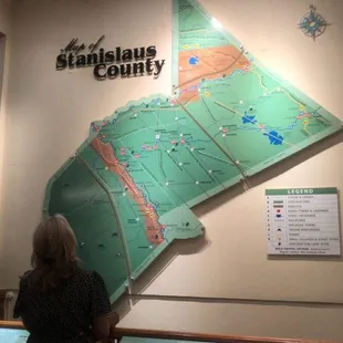 My mom looking up at the Stanislaus County map.