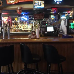 a bar with black chairs