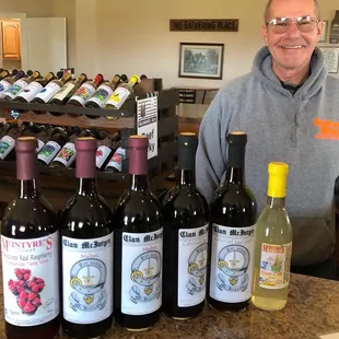 a man standing in front of bottles of wine