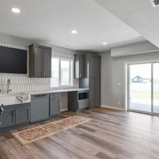 Basement Remodel Project, LVT Flooring, Quartz Countertops, Tile Backsplash by McKean's