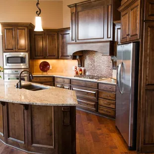 New Home Construction - Hardwood floor, granite countertops and tile backsplash by McKean's