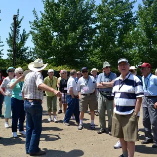 Farmer Bob giving a bus group a tour of the farm.