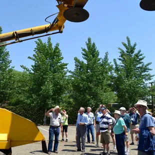 Tour guests getting an up close view of some farm equipment.