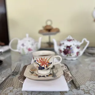 a table setting with a cup and saucer