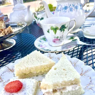 a plate of sandwiches and a cup of tea