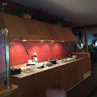a view of a kitchen with a red wall