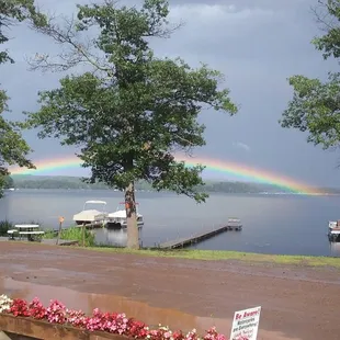 a rainbow in the sky over a lake