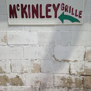 a sign on a brick wall