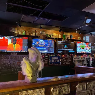 a woman in a white dress sitting at the bar