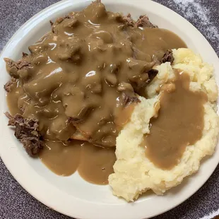 a plate of mashed potatoes and gravy