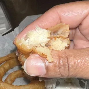A close-up of the uncooked interior of the raw onion ring.