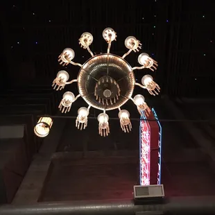 a chandelier with hands and hands