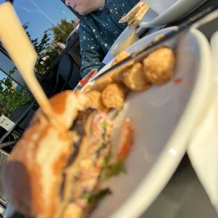 My daughter in the backdrop of my burger