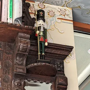 Nutcracker reminder atop a little library...