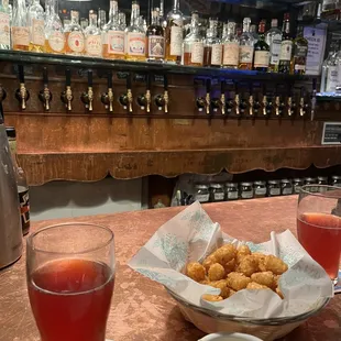 a bowl of onion rings and a glass of beer