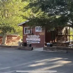 a small building in the middle of a parking lot
