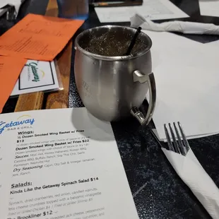 a menu and a cup of coffee