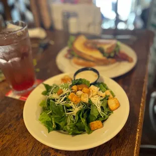two plates of salad and a drink