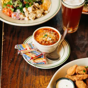a bowl of soup and a plate of chicken nuggies