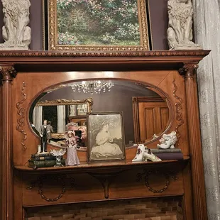 a fireplace mantel with a mirror above it