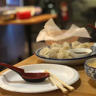 a bowl of soup and a plate of dumplings