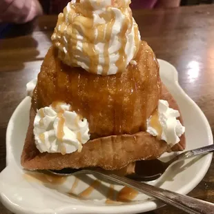 a waffle sundae with whipped cream and a cherry on top