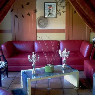 a living room with red leather furniture