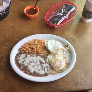 2 eggs with a side of rice and beans.