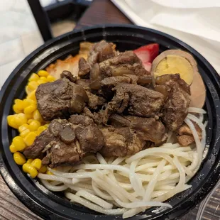 a bowl of beef and noodles