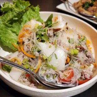 a bowl of salad with a fork in it