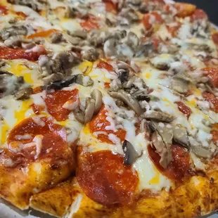 Large pepperoni and mushroom pizza