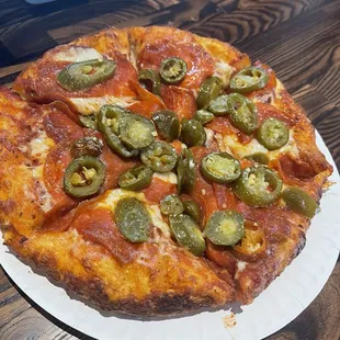 ows a pizza on a paper plate