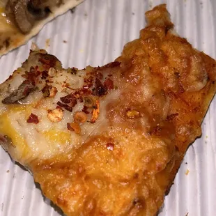 Hair in the pizza, near the crust.