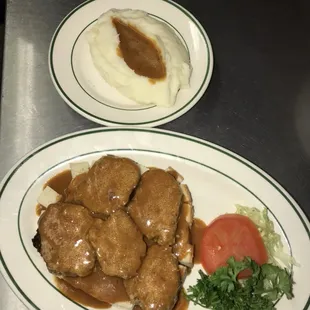 Open faced meatloaf sandwich with side of mashed potatoes