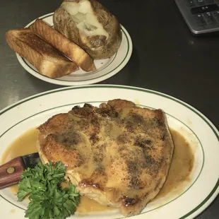 Pork chop with baked potato and Texas toast